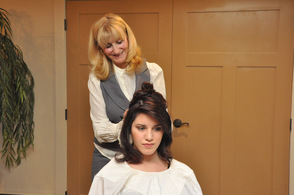 Maryse Denzer styles Hannah Paternoster's hair.