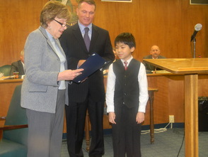 Millburn Mayor Sandy Haimoff and Essex County Clerk Christopher Durkin presenting Alexander Ma with a proclamation for his artwork