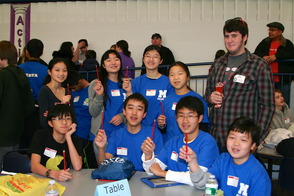 The MMS Mathletes receive some sharpened Mathcounts pencils by a volunteer from Montclair State University.
