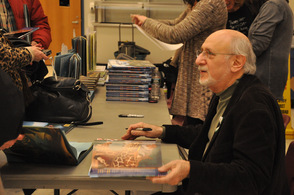 Peter Yarrow signing books for fans.