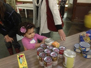 Preschooler, Luzita Avila of Maplewood, helps sort food and has a hands-on lesson about repairing the world when she visited the Interfaith Food Pantry of the Oranges with her preschool class at Temple Sharey Tefilo-Israel of South Orange.