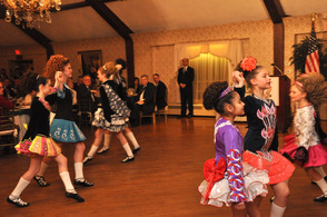 Dancers form two lines in the middle of the ballroom.