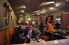 Chamber members sit and enjoy the BBQ Fusion hors d'oeuvres.