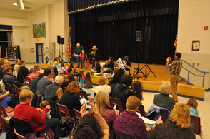 Audience members gather around Yarrow onstage.