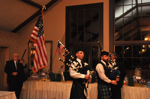 Pipers lead in the flag bearers.