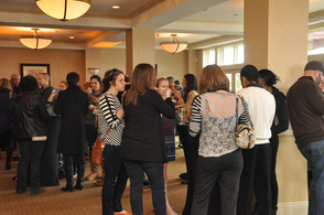 Guests mingle and sample macaroni and cheese.