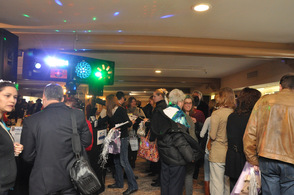 Attendees are drawn into one of the rooms, filled by strobe lights, sun tan spraying booths, food, and more.