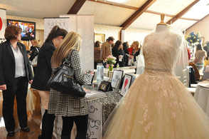 A bride-to-be stops to Sew 'N Sew Bridal and Tuxedo's table for information.
