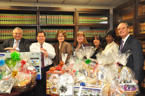 From left to right: Richard Pompelio, Stephen Davis, Sue Nagel, Barbara Lemley, Debbie Rubio, Della Wallace, and Donald DiFrancesco, surround the items, which will help raise money for the New Jersey Crime Victims' Law Center.