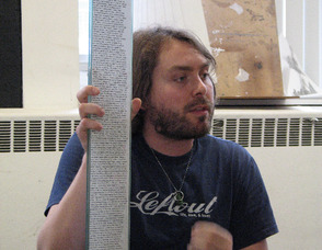 Poet Britt Melewski, with his 9/11-themed GlassBook Project entry.
