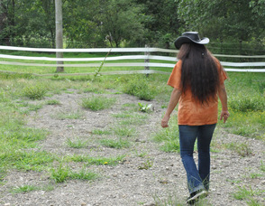 Diane Romano walks through the now rocky riding ring area.