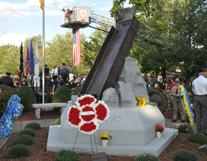 Members of the audience surround the memorial after the program.