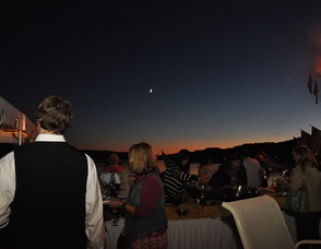 A pink sunset meets the crescent moon, over the Lake Mohawk Country Club, and Boardwalk.