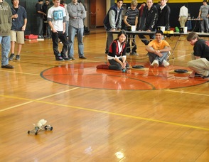 Madison High School students watch the cars on the track during the race.