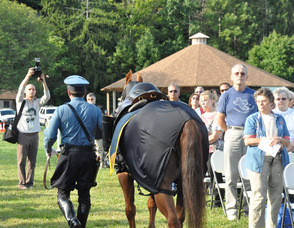 SSGT Joseph Geraci, Retired from the New Jersey State Police escorts retired New Jersey State Police mount, Tonto Thomas, through the audience.