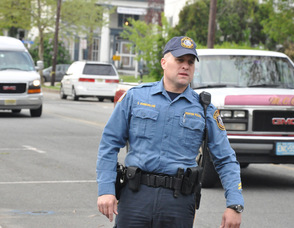 Officer Steven VanNieuwland guides students along Trinity Street.