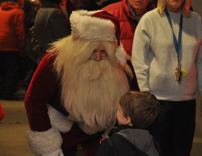 A little boy speaks to Santa.