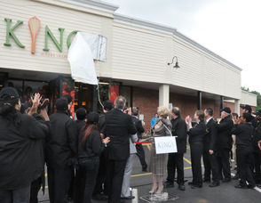 Kings Food Markets Judy Spires unveils the store's new sign.