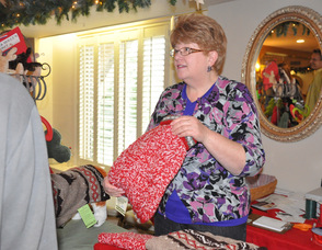 Bonnie Bitondo of Maxwell & Molly's Closet Pet Boutique holds up a sweater, ready to give to a four-legged friend.