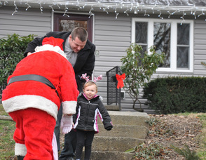 Sierra Arfken, age 2, greets Santa with a smile.