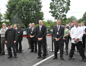 Employees listen to Spires at the grand reopening.