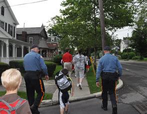 Police and students walk along Trinity Street.