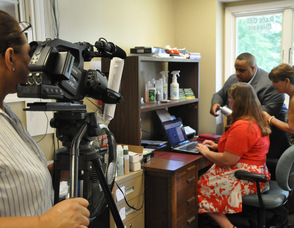 Zaida Collazo filming Ron Gaines, Patricia Singer, and Rosanne Turkington.