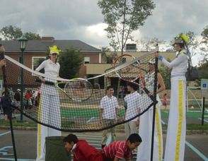 People on stilts playing tennis