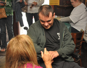 A friend talks to Scott Harris during the event.