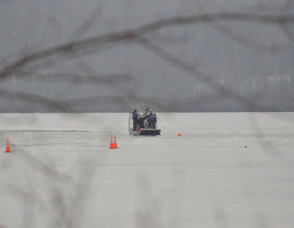 The New Jersey State Police Vessel combs the lake, and makes its way through the ice.