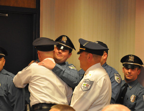 Andover Township Police Officers congratulate their colleague, Eric Danielson, after he has taken his oath as lieutenant.