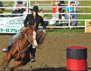 Lisa Barone and one of her horses proceed around a barrel.