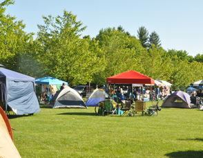 Tents lined up along the lawn of Sussex County Community College of the participants.