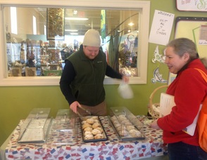 A customer buys up a scone from Rob Cadigan of The Pear Tree Pantry.
