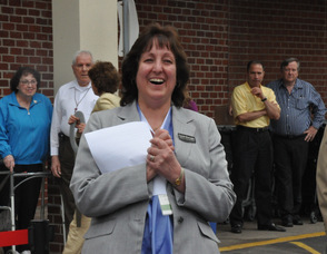 General Store Manager Carole Bracaglia applauds Spires.