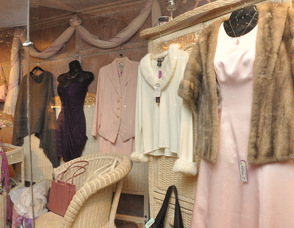 An array of outfits in the window of Diva Designs.
