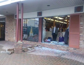 The window at Adam's Fine Clothing smashed