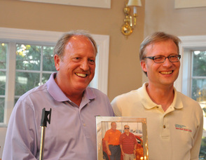Bill Snouffer holds up the gift presented to Snouffer for his chairing of the golf outing.