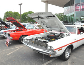 Dodge Challengers lined up in the dealership's lot.