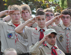 Scouts salute during the raising of the flag.