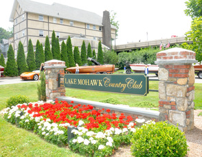 Boats on display around the horseshoe at the entrance to the Lake Mohawk Country Club.