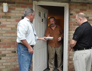 Andover Township Mayor Michael Lensak, and Scott Milliken, Executive Director at the Diocese of Paterson, deliver a meal to Donald Moss of Newton.