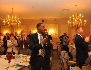 Attendees give a standing ovation to Richard Vohden.