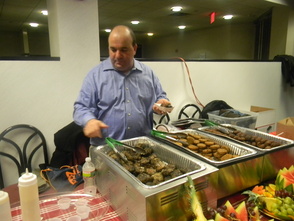 Co-owner Yoram Aflalo of Deena's Delights serving meatballs