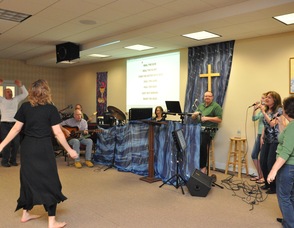Participants dance and sing along with the worship team's music.