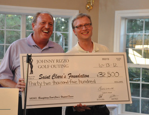 Bill Snouffer, Tournament Chair and Jeff Lamie from the Saint Clare's Foundation, hold the check raised from the golf outing.