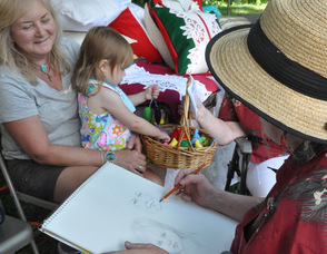 Lori Harden, portrait artist, draws Val Cerny and her granddaughter, Alaina.