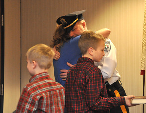 Eric Danielson embraces wife Debbie, after taking his oath, as sons Patrick and Matthew look on.