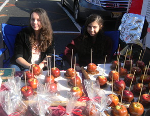 Nicole Goldshmidt and Sarah Abbott, of Girl Scout Troop 140, who made and sold caramel apples