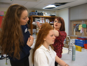Becky Lawrence of Salon FiG teaches Courtney Milton (left) and Jennifer Dupre (sitting, center), how to create 'Hairspray' era styles.